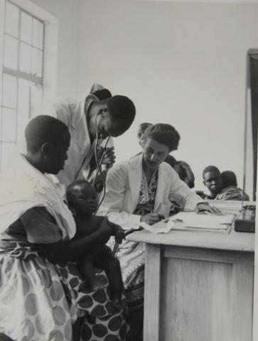 A Medical Doctor (R) assisted by student Interns