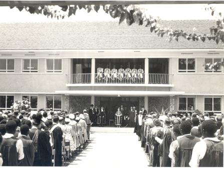 Her Majesty Queen Elizabeth, the Queen Mother then Chancellor University of London, Staff and Studens stand as the National Anthem is played by the Police Band at Makerere Univeristy, Kampala Uganda, 20th February 1959