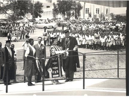 Her Majesty Queen Elizabeth, the Queen Mother assisted by the Chancellor cuts the tape to mark the official opening of the New Library Building at Makerere University, Kampala Uganda on 20th February 1959