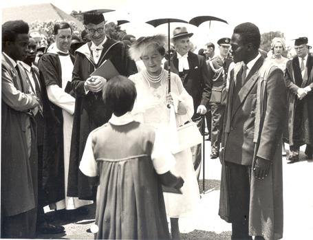 Her Majesty Queen Elizabeth, the Queen Mother receives a framed portrait of the College from a student at Makerere University, Kampala Uganda on 20th February 1959