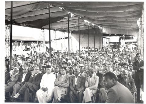 Factory employees and locals listen to Governor of Uganda Sir Fredrick Crawford K.C.M.G, O.B.E address after he opened a plywood factory at Jinja in August 1959
