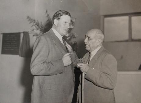 Governor of Uganda Sir Andrew Cohen (L) with a guest after officially opening the Uganda Museum's new home at Kitante on 30th June 1954