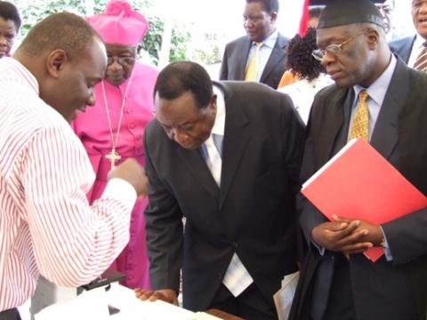 Hon. Kajura flanked by Prof. Sewankambo (R) visits the Infectious Diseases Institute (IDI) stall at the CHS Launch, 28th August 2009, Makerere University, Kampala Uganda