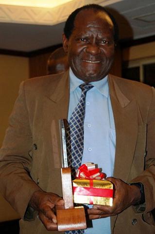 Dr. Fred Kironde, an Associate Professor of Biochemistry poses with his award at the Dinner on 20th July 2012, Kampala Serena Hotel, Uganda. Dr. Kironde has served CoNAS for 13 years. 