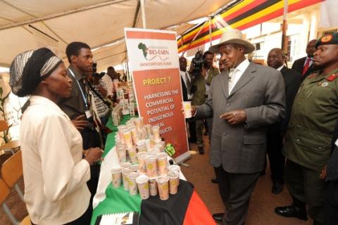 President Museveni admires canned "Bushera" during his tour of the exhibition during celebrations to mark FST 20th Anniversary 2nd October 2009, Makerere University, Kampala Uganda.