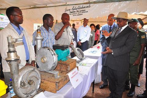 Prof. Joseph K. Byaruhanga, Principal Investigator, Low-Cost Irrigation Project (3rd L) explains the pump product range to President Museveni during his exhibition tour at the Kiira EV Launch, 24th November 2011, Makerere University, Kampala Uganda.