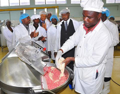 Dr. J. Muyonga, Dean, School of Food Technology, Nutrition and Bioengineering, CAES (L) explains the operations of the meat processing line to President Museveni shortly after he commissioned it on 24th November 2011, Makerere University, Kampala Uganda.