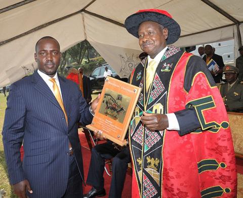 H.E. President Yoweri Kaguta Museveni displays the award received from the Chairman Makerere Convocation, Bruce Kabasa during H.E. Mwai Kibaki's Honorary Doctorate of  Laws Award ceremony, 24th January 2012, Makerere University, Kampala Uganda.