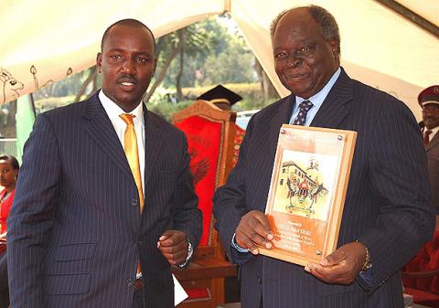 Kenyan President H.E. President Mwai Kibaki displays the award presented to him by the Chairman Makerere Convocation, Bruce Kabasa during his Honorary Doctorate of  Laws Award ceremony, 24th January 2012, Makerere University, Kampala Uganda.