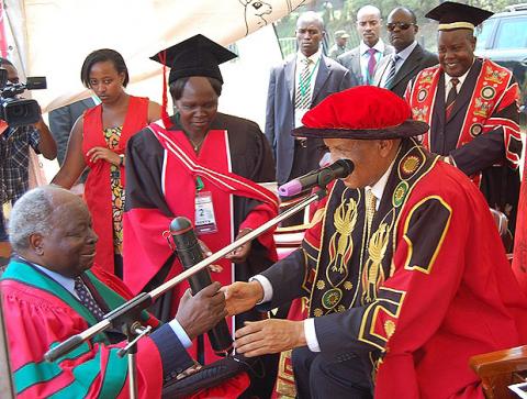 President Mwai Kibaki receives his Honorary Doctorate of Laws Award Letter from The Chancellor Prof. George Mondo Kagonyera  during the Award ceremony, 24th January 2012, Makerere University, Kampala Uganda.