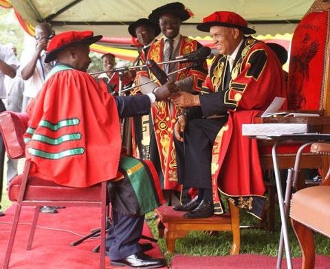 H.E. President Yoweri Museveni receives his Honorary Doctorate of Laws Award Letter from The Chancellor Prof. George Mondo Kagonyera during the Award Ceremony on 12th December 2010, Makerere University, Kampala Uganda.