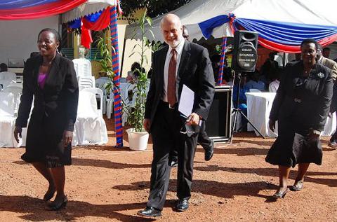 Dr. Jennifer Namusobya (L) accompanied by Dr. Jane Bosa (R) leads U.S. Ambassador Scott DeLIsi on a tour of the facility during the SMC Launch on 11th December 2012, Makerere University Hospital, Kampala Uganda.