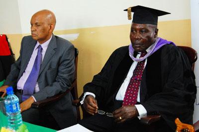 The Chancellor, Prof. Mondo Kagonyera (L) and Dr. Martin Aliker (R) listen to proceedings.