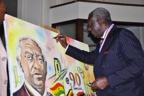 H.E. John Kufuor (L) autographs the souvenir live painting after delivering a Public Lecture on Oil, Mak@90, 2nd August 2013 Makerere University, Kampala Uganda.