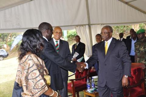 Mr. Mutekanga Igaga (2nd L) is congratulated upon his recognition as Composer of the Makerere Anthem by The Prime Minister Rt. Hon. Amama Mbabazi (R) during the Mak@90 Grand Finale Celebrations, 3rd August 2013, Freedom Square, Makerere University, Kampala Uganda.