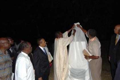 The Chief Guest Prof. Ephraim Kamuntu assisted by Dr. Alan Birabi and witnessed by Prof. Ngugi wa Thiongo (2nd L), Rt. Hon. Apolo Nsibambi (3rd L) and Prof. G. Kagonyera (R) launch the Mwalimu Nyerere Bust during the UEA celebrations, 29th June 2013, Makerere University, Kampala Uganda.