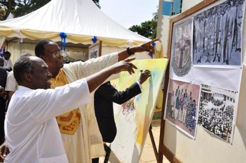 Prof. Ngugi wa Thiong'o (L) and Prof. Ephraim Kamuntu admire pictures from the UEA era at a mini-exhibition during the UEA 50th Anniversary celebrations 29th June 2013, Makerere University, Kampala Uganda.